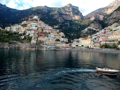 A modern gozzo boat turning near Positano coast