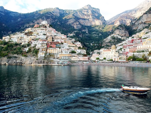 Tour in Amalfi with a modern gozzo boat turning near Positano