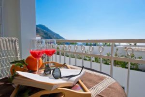 Casa Coccinella terrace with book sunglasses and drinks on the table
