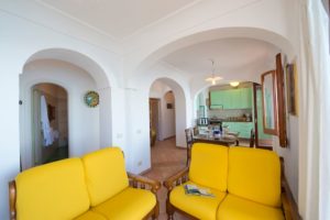 Casa Regina interior living room with yellow sofas