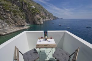 Casa Terramare terrace on sea and coast with wine and glasses on the table