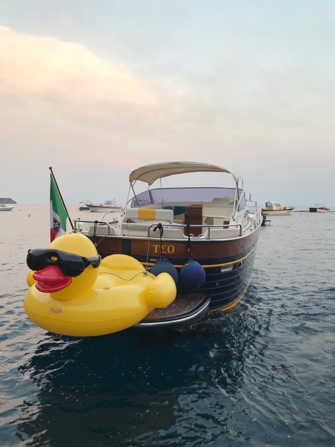 The modern gozzo boat with a yellow duck on the sea