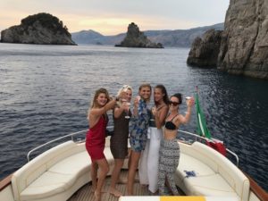 A group of girls happy toasting prosecco on the boat